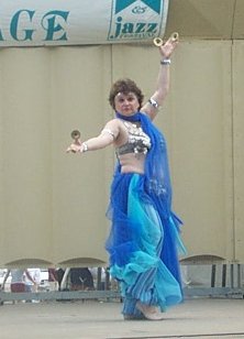 dancer in blues playing finger cymbals