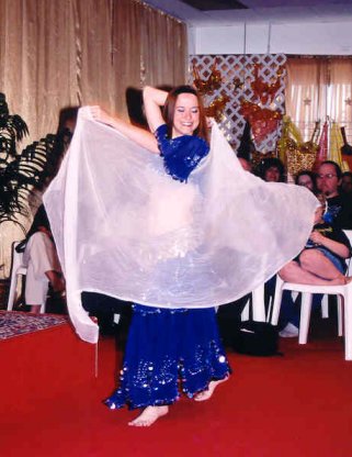 dancer in royal blue with white sheer veil