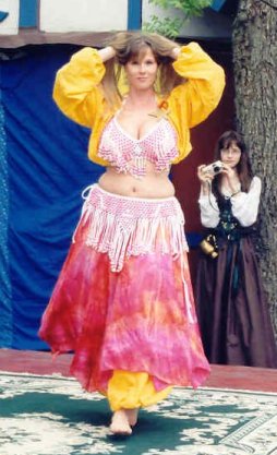 dancer in yellow and pink performs
