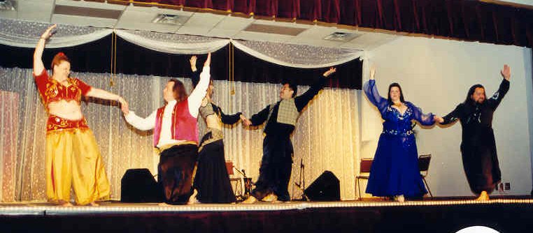 group of dancers perform on stage