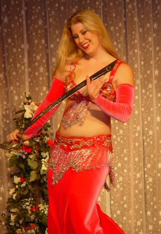 dancer in pink velvet holding sword