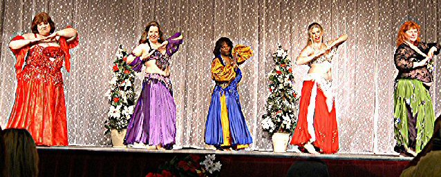 group of dancers in multi-colored costumes on stage