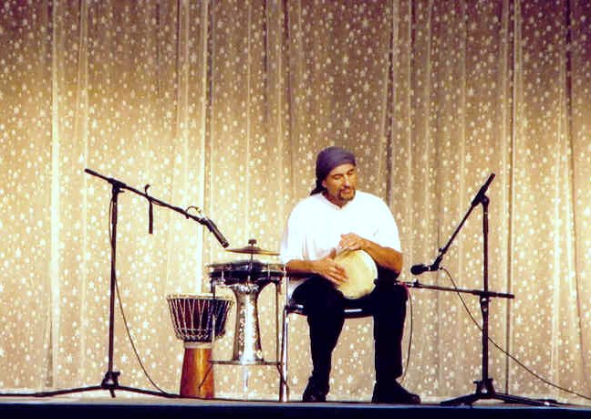 Jamal performs on stage with multiple instruments