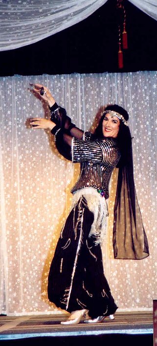 dancer in black with long headwrap draping down