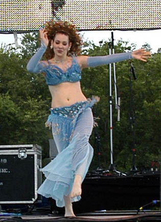 Dancer Sadiyya in pale blue kicks out during performance