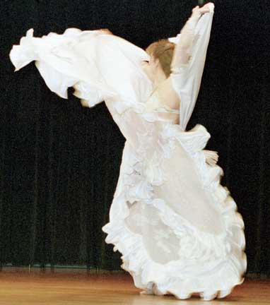 dancer Isabella on stage wearing white with full white veil