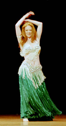 dancer Nezrana performs wearing a green skirt with silver bedlah