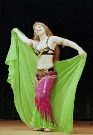 dancer Rachael performs wearing pink and green costume with green veil
