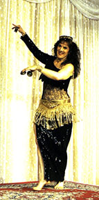 dancer with dark hair in black sequined costume
