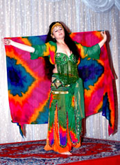 dancer wearing boldly colored costume with matching veil