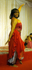 performer wearing orange-red performs near the audience