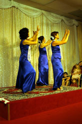 4 dancers in blue perform on stage