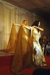 dancers in gold perform with sheer gold veils