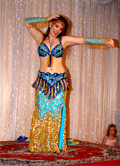 dancer wearing blue and gold costume performs