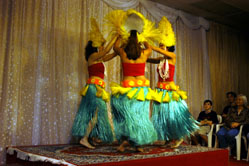 dancers wearing brightly colored costuming perform on stage