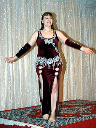 dancer wearing a burgandy velvet dress on stage