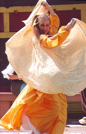 Dancer Sarafina performs with veil, dressed in yellow