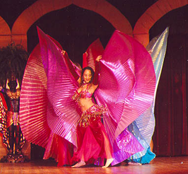dancers on stage, back to back, with wings outstretched