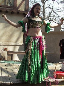 dancer in green costume with pink accents on stage