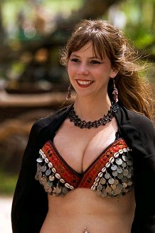 dancer wearing black and silver shown smiling in between performances