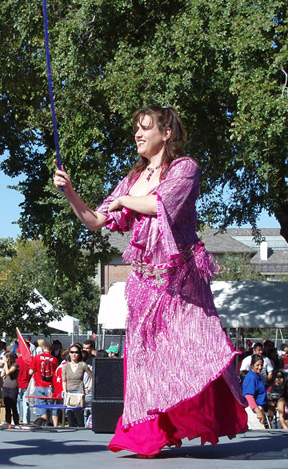 dancer in pink performs with a cane
