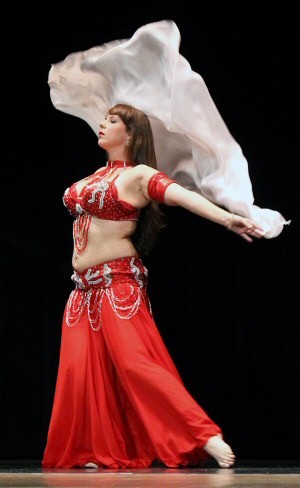 dancer in all red performs with a white veil
