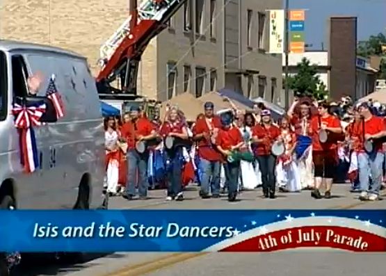 dancers wearing red, white, and blue participate in the Arlington 4th of July Parade in 2012
