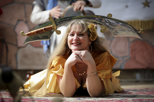 helena in gold with swords balanced on head